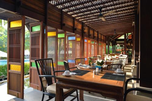 a dining room with a table and chairs at Khaolak Bhandari Resort & Spa in Khao Lak