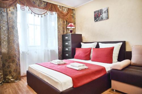 マグニトゴルスクにあるFive Stars on Leninaのベッドルーム1室(赤い枕のベッド1台、窓付)
