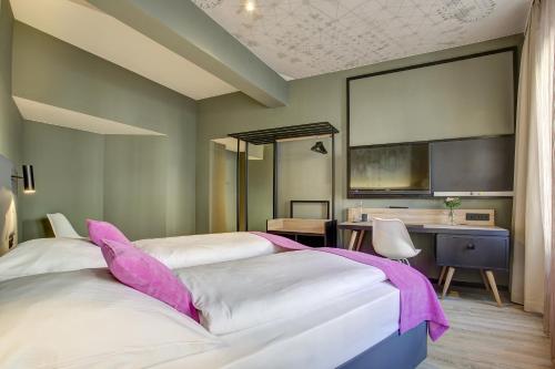 a hotel room with two beds and a desk at Boutique 003 Köln City am Dom, Trademark Collection by Wyndham in Cologne