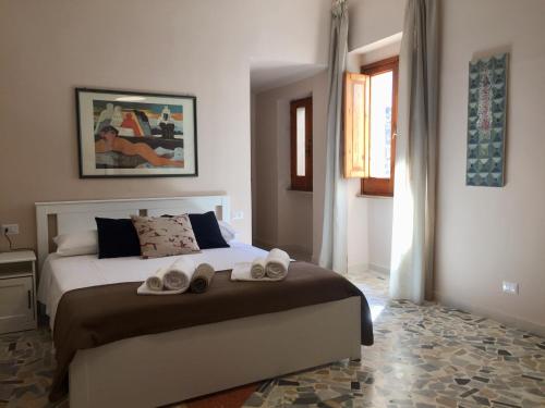 a bedroom with a bed with two towels on it at Conte Spada Home in Nardò