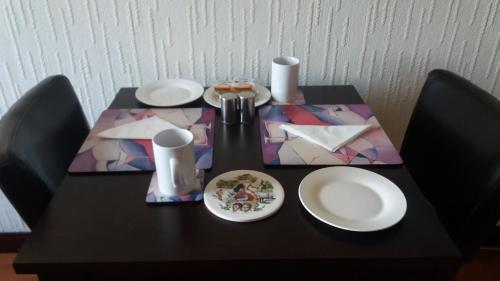 a black table with white plates on top of it at Celicall in Ballater