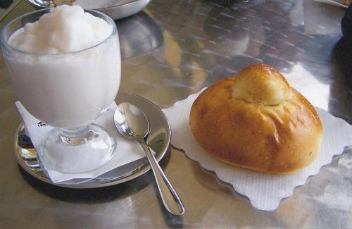 a table with a glass of milk and a pastry and a drink at Scariceddu in Riposto