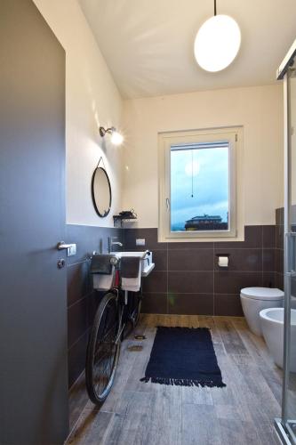 a bathroom with a bike hanging on the wall at Nonna Giulina in Castagnole Lanze