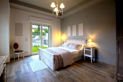 a bedroom with a large bed and a window at Nonna Giulina in Castagnole Lanze