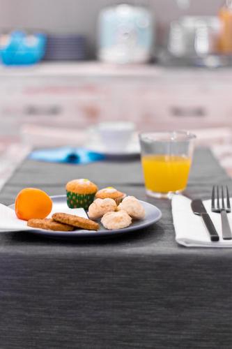 a plate of food on a table with a glass of orange juice at Nonna Giulina in Castagnole Lanze
