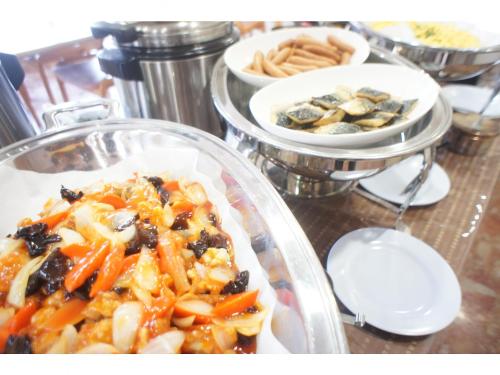 a plate of food on a table with other plates of food at APA Hotel Suzuka-Chuou in Suzuka