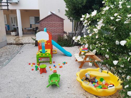 
a small playground with toys and toys in it at Apartments Kairos - Bili 9 in Kaštela
