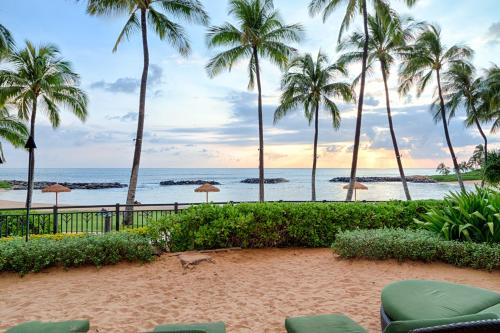 a view of the beach and palm trees at Third Floor villa Ocean View - Beach Tower at Ko Olina Beach Villas Resort in Kapolei