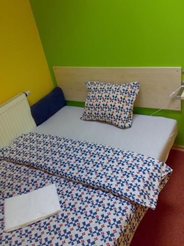 a bed with two pillows on it in a room at Penzion Cihelna in Brno