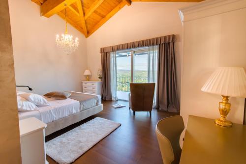 a bedroom with a bed and a desk and a window at Wine Residence Cattunar in Brtonigla