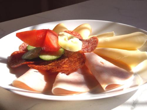 a plate of food with vegetables on a table at Éden Villa Apartmanház in Balatonfüred