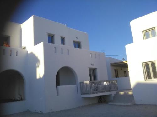 a white building with a balcony in front of it at Magic View II Agia Anna in Agia Anna Naxos
