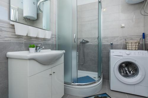 ein Badezimmer mit Waschbecken und Waschmaschine in der Unterkunft Apartments Mirko&Ana in Bibinje