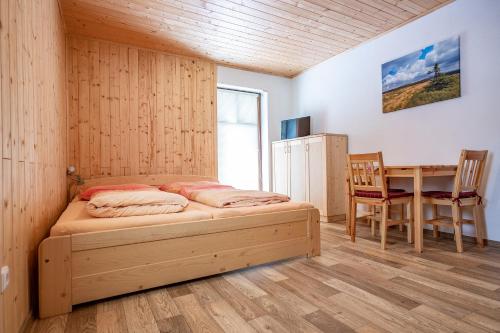 a bedroom with a bed and a desk and a table at S4 Resort Kouty in Loučná nad Desnou