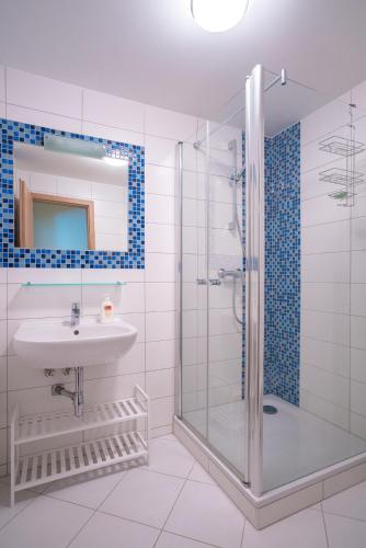 a bathroom with a sink and a shower at S4 Resort Kouty in Loučná nad Desnou