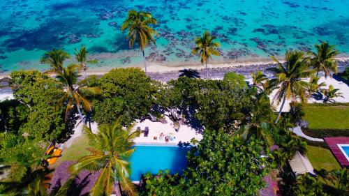 an aerial view of a beach with palm trees and a pool at Maui Palms in Korolevu