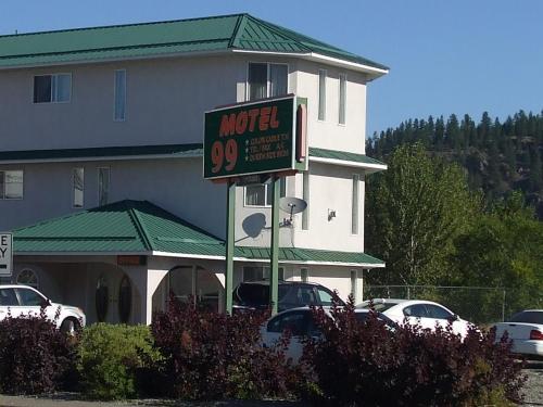 a motel sign in front of a large building at Motel 99 in Grand Forks