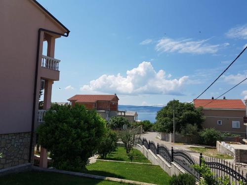a view of the ocean from a house at Apartments Ban in Novi Vinodolski