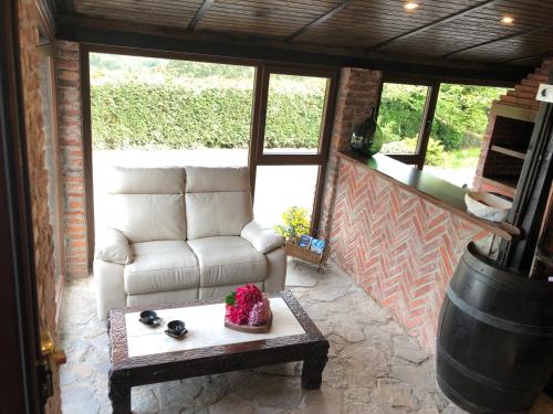 a living room with a couch and a coffee table at Hotel Tejera del Nalon in Soto del Barco