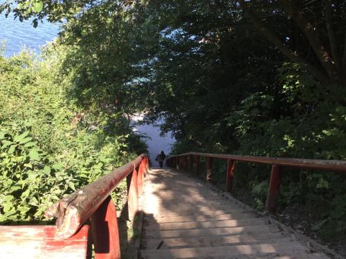 a person walking across a wooden bridge over a trail at Hørhavegården B&B in Højbjerg