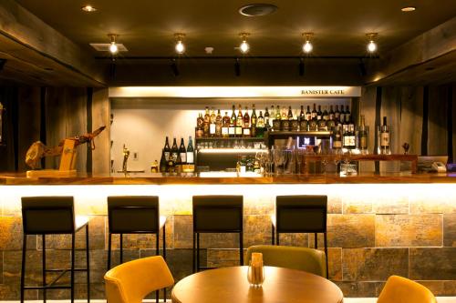 a bar with chairs and tables in a restaurant at Hotel Banister Kyoto in Kyoto