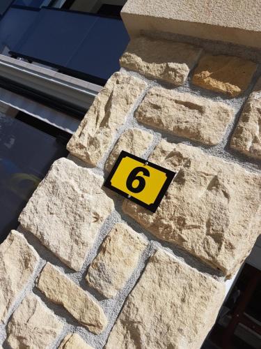 a stone wall with a number six on it at Smart Urban Orio in Orio