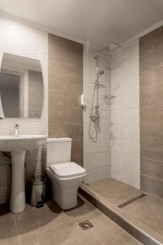 a bathroom with a toilet and a sink and a shower at Zante Calinica Hotel in Tsilivi