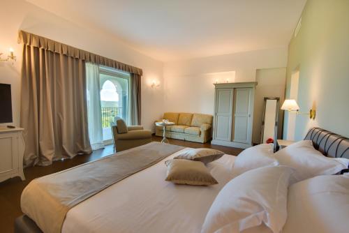 a bedroom with a large bed with white pillows at Wine Residence Cattunar in Brtonigla
