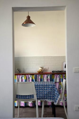 a kitchen with a table and two chairs and a table at Casa le Gebbie in Marzamemi