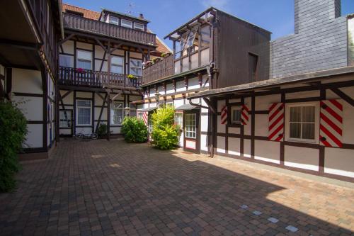 an empty courtyard of a building with flags on it at Gästehaus Schmitz in Goslar