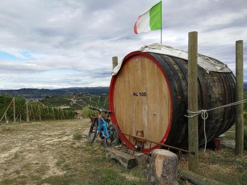 a large wooden barrel with a bike parked next to it at - Home Sweet Langhe - Room 51 in Alba