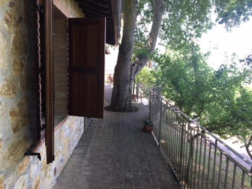 a building with a gate and a brick walkway at SetterHouseAgriHotel in Trevi