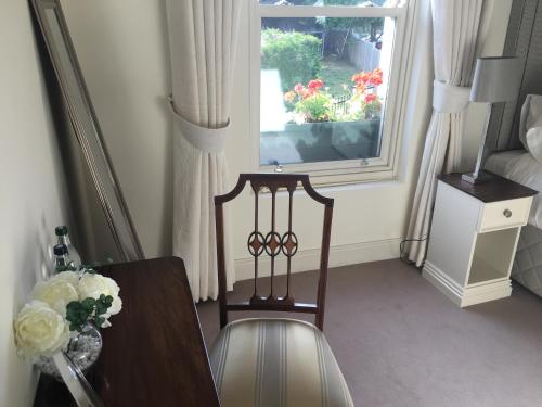 a room with a table and a chair and a window at Horse & Hound in Delgany