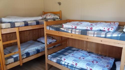 a room with three bunk beds in it at Furusjöns Cottage in Ånimskog