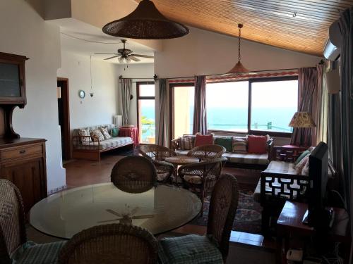 a living room with a table and chairs at Villa Mariedda in Taormina