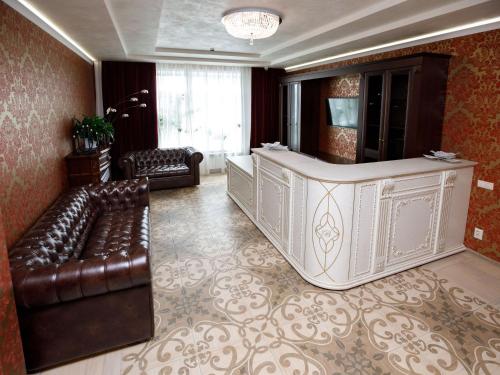 a lobby with a waiting room with leather furniture at Hotel "Vernissage" in Yoshkar-Ola