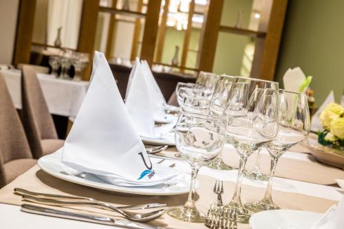 a table with wine glasses and napkins on it at Unique - Resort and SPA in Ohrid