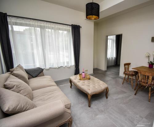 a living room with a couch and a coffee table at B&B De Bloesem in Hoeselt