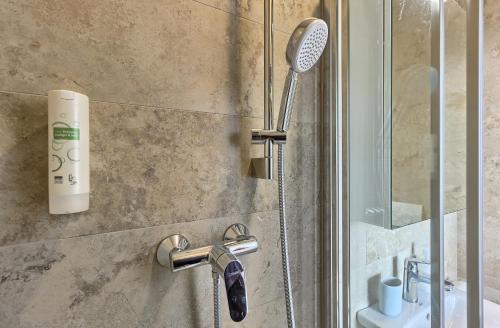 a shower with a shower head in a bathroom at Golden Haven in Murter