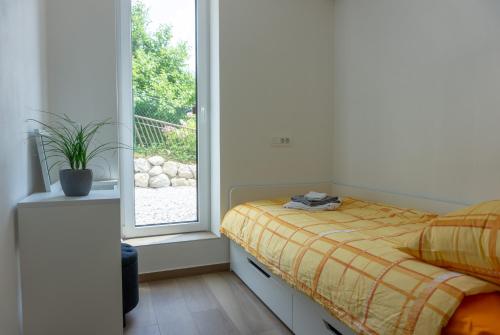 a bedroom with a bed and a window at Nature View House with Sauna in Tolmin