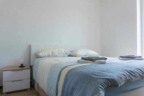 a bedroom with a bed with two towels on it at Nature View House with Sauna in Tolmin