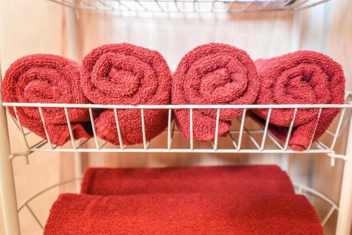 a bunch of red towels in a closet at Ardonas in Šventoji