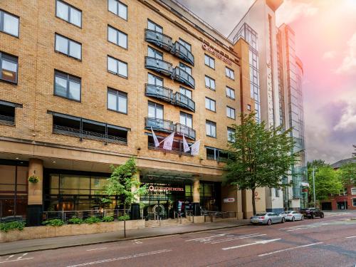 a large brick building on a city street at Clayton Hotel Belfast City in Belfast