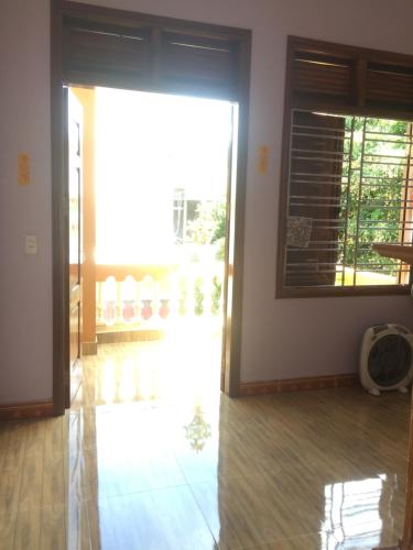a room with a door open to a balcony at Cat Ba Mystery Homestay in Cat Ba