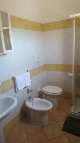 a bathroom with a toilet and a sink at Robbyone in Olbia