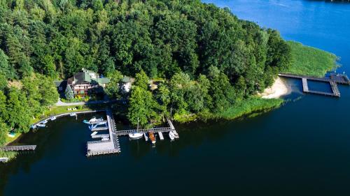 an aerial view of a house and boats on a lake at Przystanek Zatoka in Olsztyn