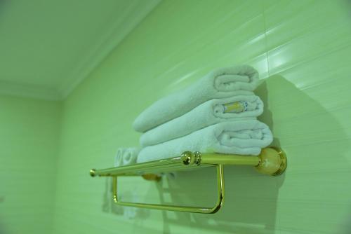 a pile of towels on a towel rack in a bathroom at Euro Star Hotel in Katunayake