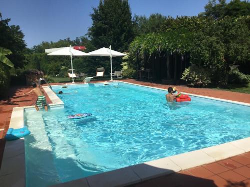 a group of people in a swimming pool at La Pergola B&B in Cesena