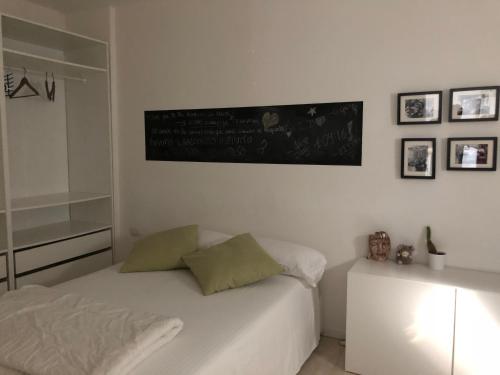 a bedroom with a bed and a chalkboard on the wall at Lovely apt. only 300mt. Monza F1 Circuit-Park-Golf in Biassono