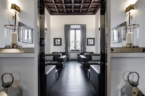 a salon with black chairs and a waiting room at LHP Hotel River & SPA in Florence
